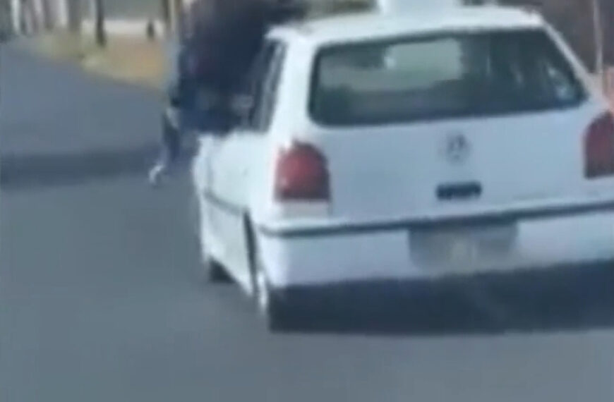 Driver Pretends To Surf On The Roof Of His Moving Vehicle In Middle Of Traffic